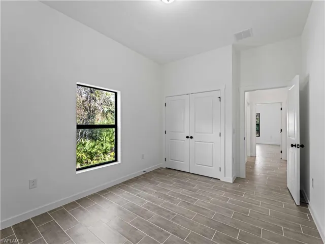 Unfurnished bedroom featuring a closet and light hardwood / wood-style flooring