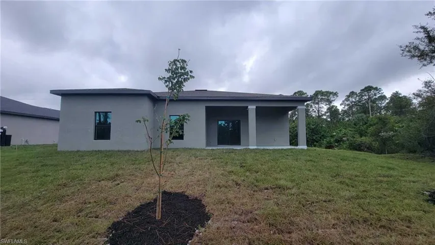Back of property with a yard