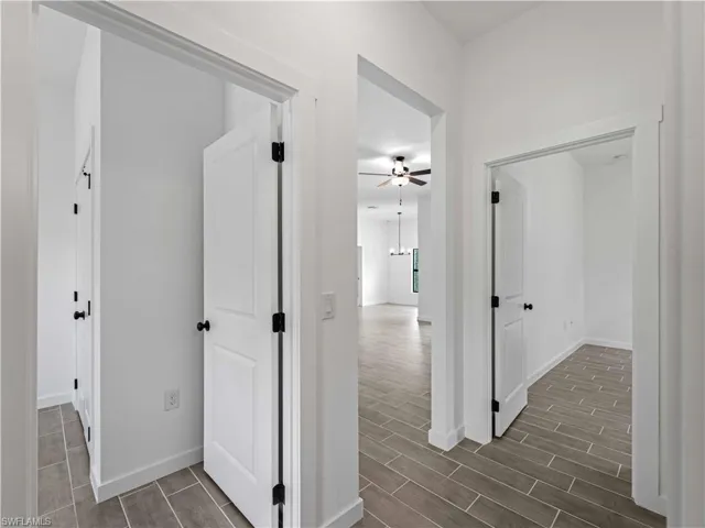 Corridor with dark hardwood / wood-style flooring