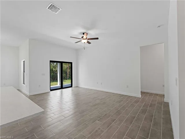 Spare room featuring ceiling fan and dark hardwood / wood-style flooring