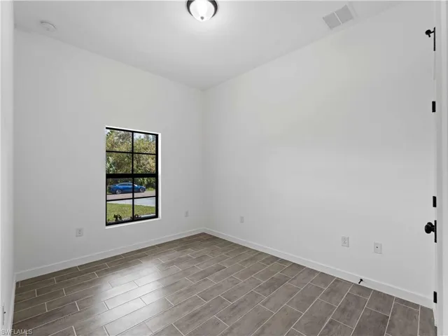 Empty room featuring wood-type flooring