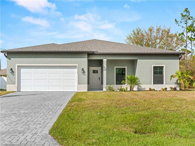 View of front of house with a front lawn and a garage