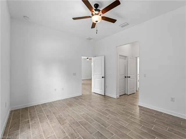 Spare room with light hardwood / wood-style flooring and ceiling fan