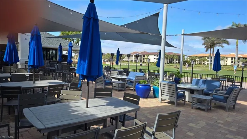 View of patio with an outdoor living space with a fire pit and outdoor dining area