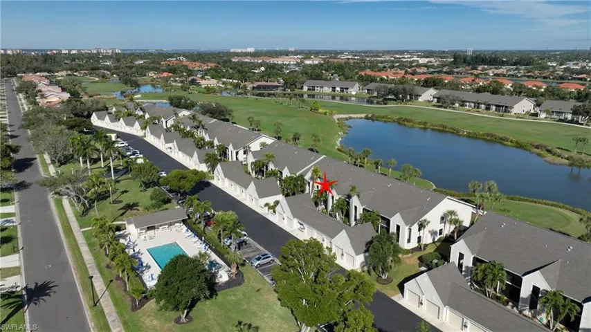 Aerial view of property's location with a large body of water and nearby suburban area