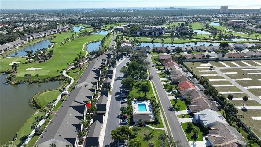 Aerial overview of property's location with nearby suburban area, a nearby body of water, and a local golf course