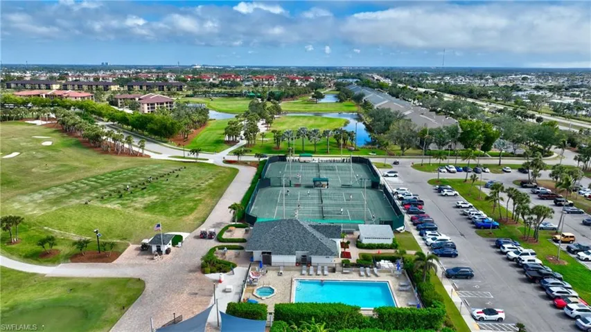 Drone / aerial view of a nearby body of water and a local golf course