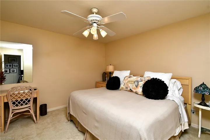 Bedroom featuring light carpet and a ceiling fan