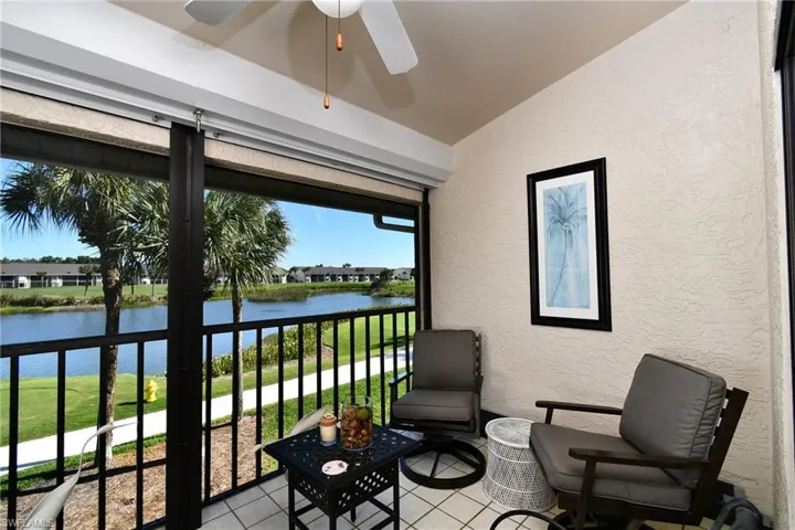 Sunroom / solarium with a water view and vaulted ceiling