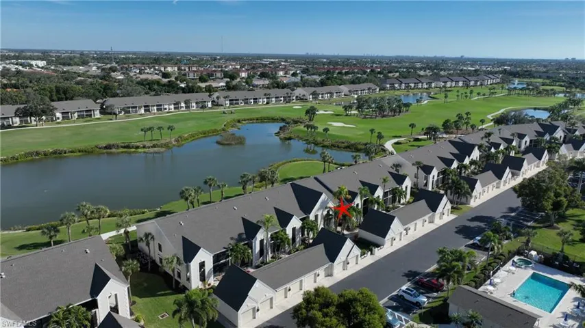 View of property location with a golf course and nearby suburban area
