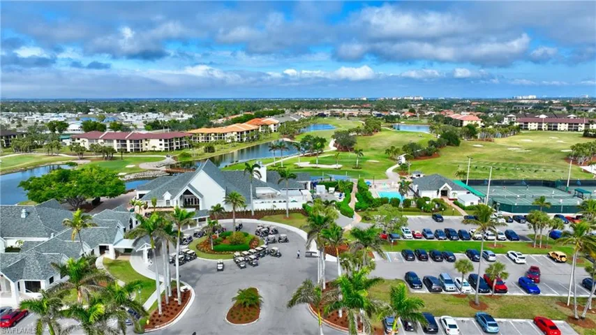 Drone / aerial view of a nearby body of water and a local golf course