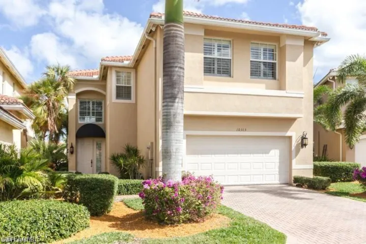Mediterranean / spanish home with an attached garage, decorative driveway, stucco siding, and a tiled roof