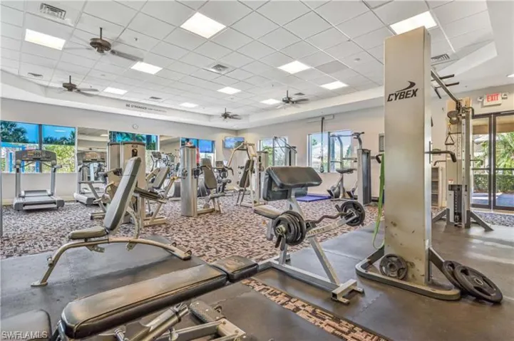 Workout area with a paneled ceiling and ceiling fan