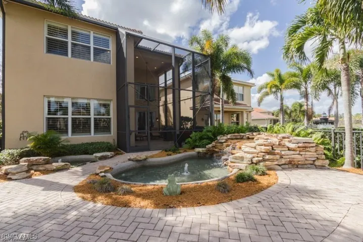Surrounding community with a patio area, a water feature, and a sunroom