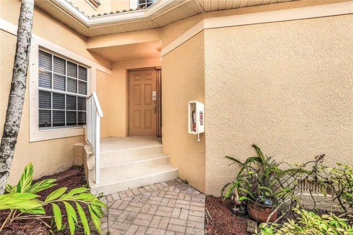 Property entrance with stucco siding