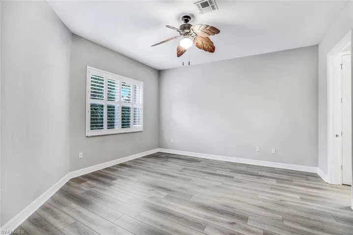 Spare room with a ceiling fan and light wood-style floors