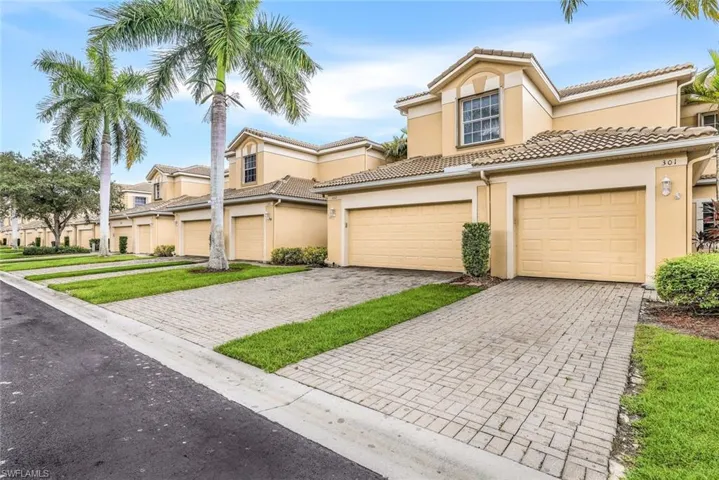 Mediterranean / spanish-style house with stucco siding, decorative driveway, a garage, and a tiled roof