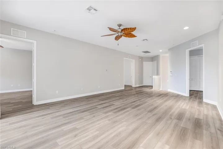 Unfurnished living room with a ceiling fan, recessed lighting, and light wood-style flooring