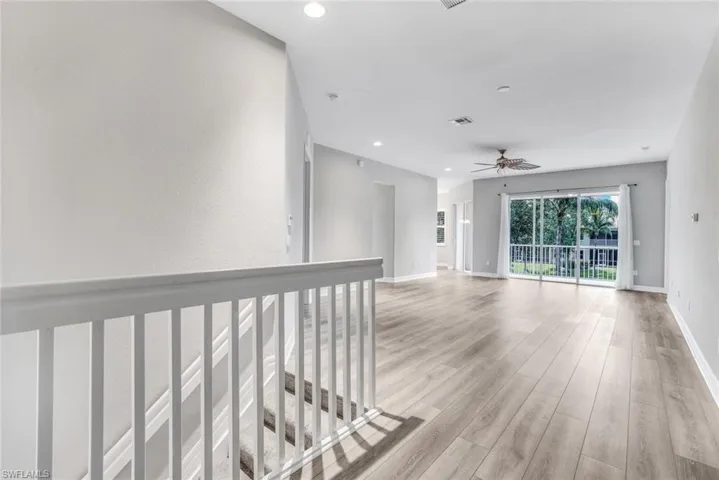 Hall featuring light wood-type flooring and recessed lighting