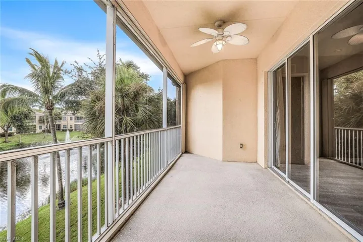 Unfurnished sunroom featuring healthy amount of natural light, lofted ceiling, and a water view