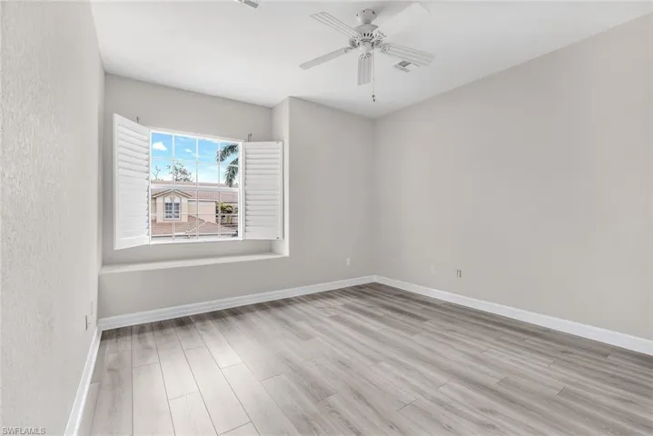 Unfurnished room featuring light wood finished floors and ceiling fan