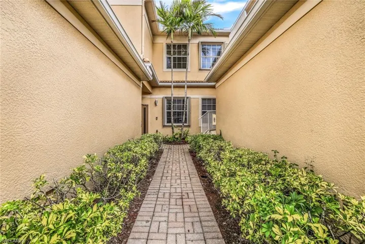 Property entrance featuring stucco siding