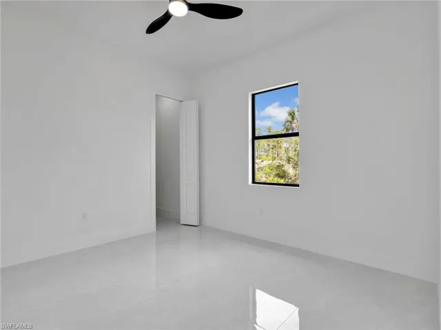 Spare room featuring baseboards and a ceiling fan