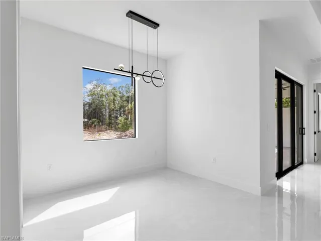 Unfurnished dining area featuring a chandelier
