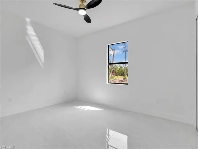 Unfurnished room featuring baseboards and ceiling fan