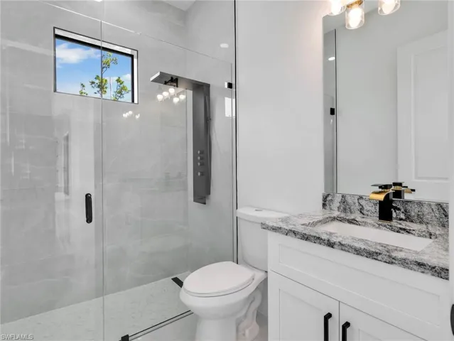 Bathroom featuring vanity and a stall shower