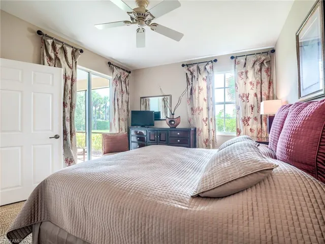 Bedroom featuring multiple windows, access to outside, and ceiling fan