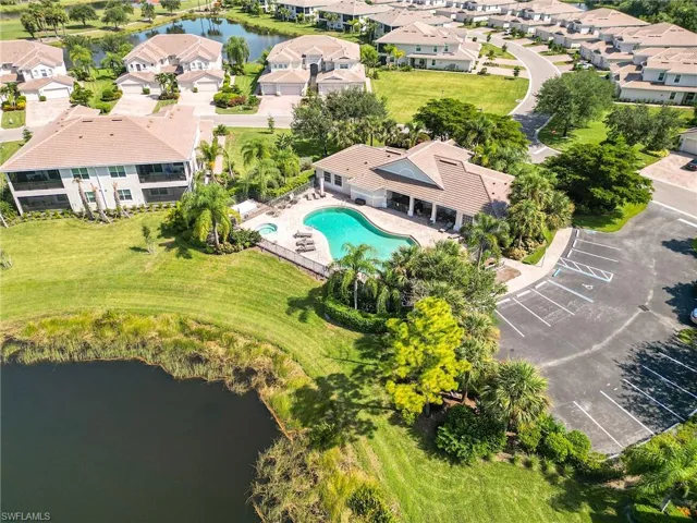 Birds eye view of property with a water view
