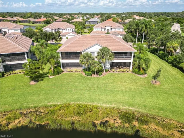 Birds eye view of property with a water view