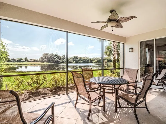 Sunroom featuring ceiling fan and a water view
