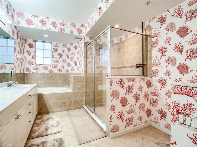 Bathroom with tile patterned flooring, vanity, and independent shower and bath