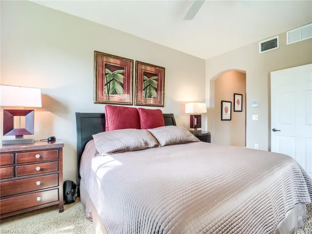 Carpeted bedroom with ceiling fan
