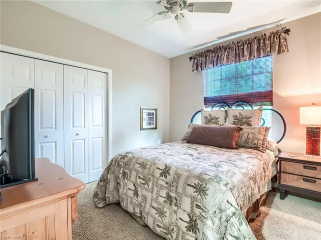Bedroom featuring carpet floors, ceiling fan, and a closet
