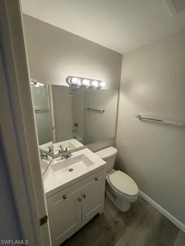Half bath with vanity and toilet
