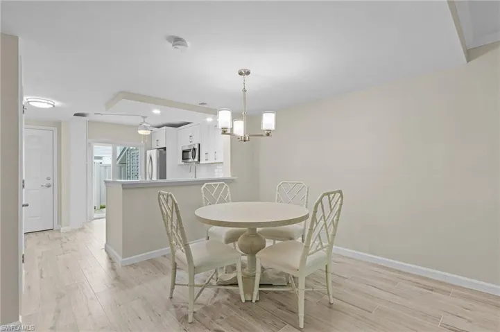 Dining room featuring light wood-type flooring and a chandelier
