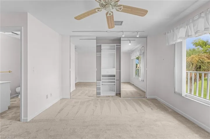 Unfurnished bedroom featuring a closet, ceiling fan, and light carpet