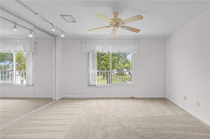 Unfurnished room with ceiling fan, carpet, and rail lighting