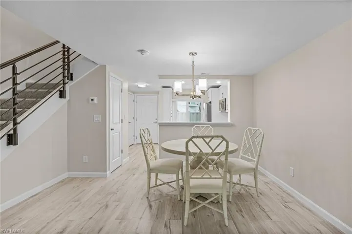 Unfurnished dining area with light wood-type flooring and a chandelier