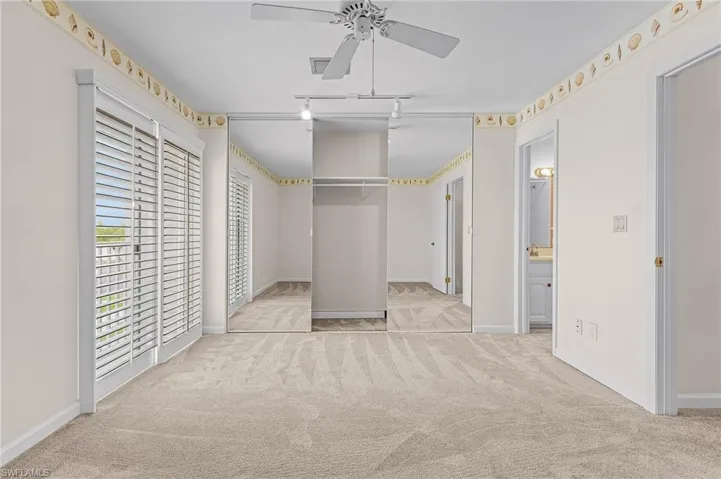 Unfurnished bedroom featuring ceiling fan, sink, and light carpet