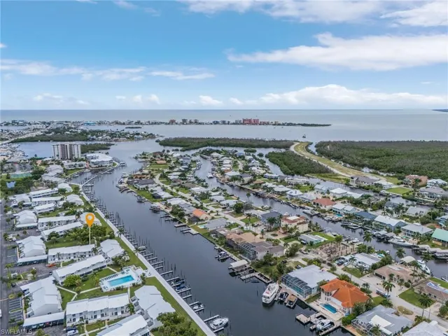 Birds eye view of property with a water view