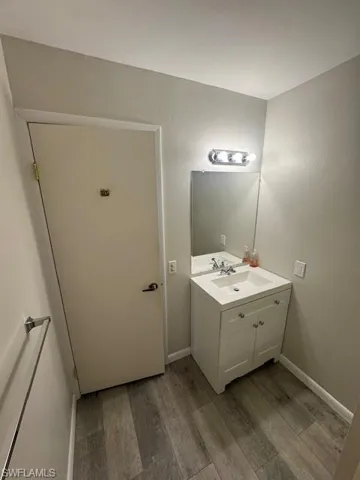 Bathroom featuring light wood-style flooring and vanity