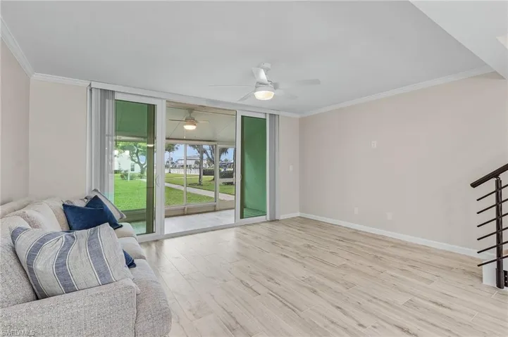 Sitting room featuring ceiling fan, light hardwood / wood-style floors, and crown molding