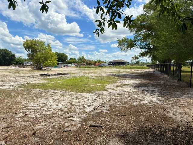 Expansive outdoor area featuring a combination of natural ground cover and sparse grassy patches