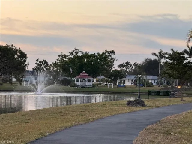 View of property's community featuring a water view, a lawn, and a gazebo