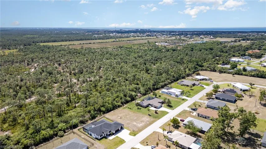 Birds eye view of property with a view of trees