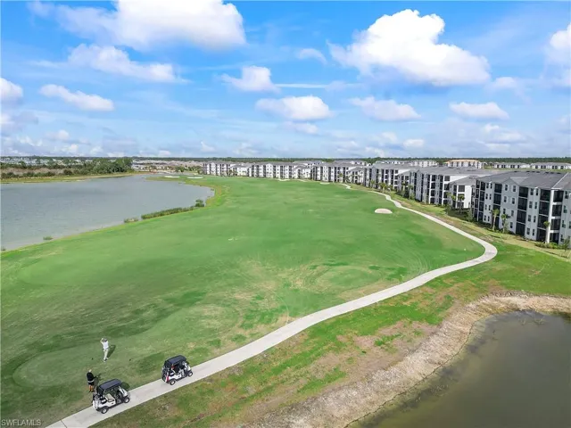 Aerial view of a golf course and a nearby body of water